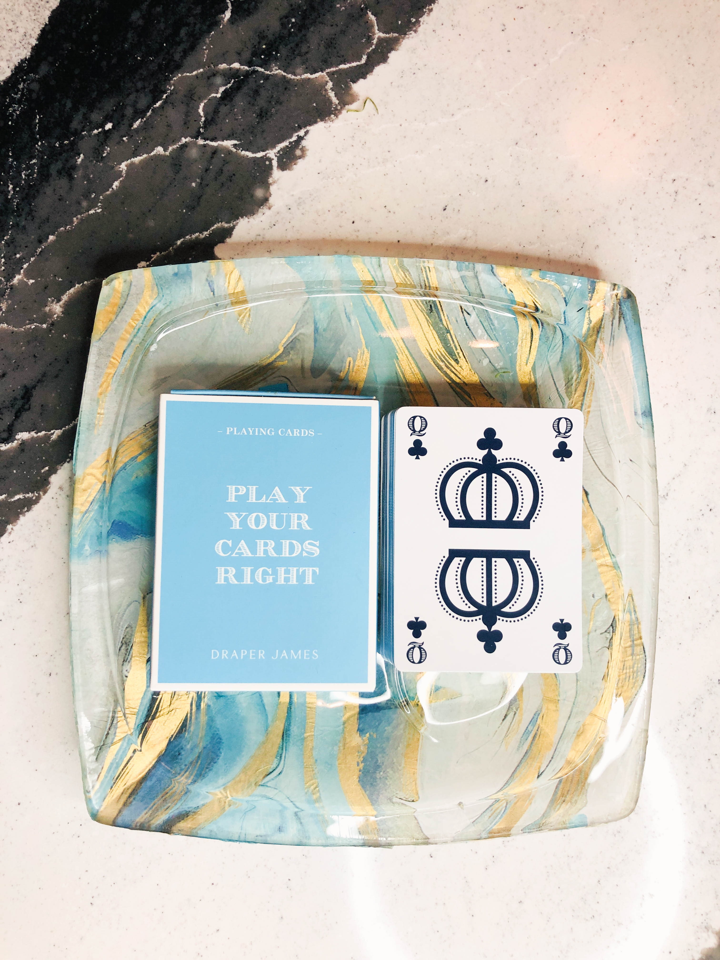 A deck of cards sitting on top of a completed glass snack plate project.