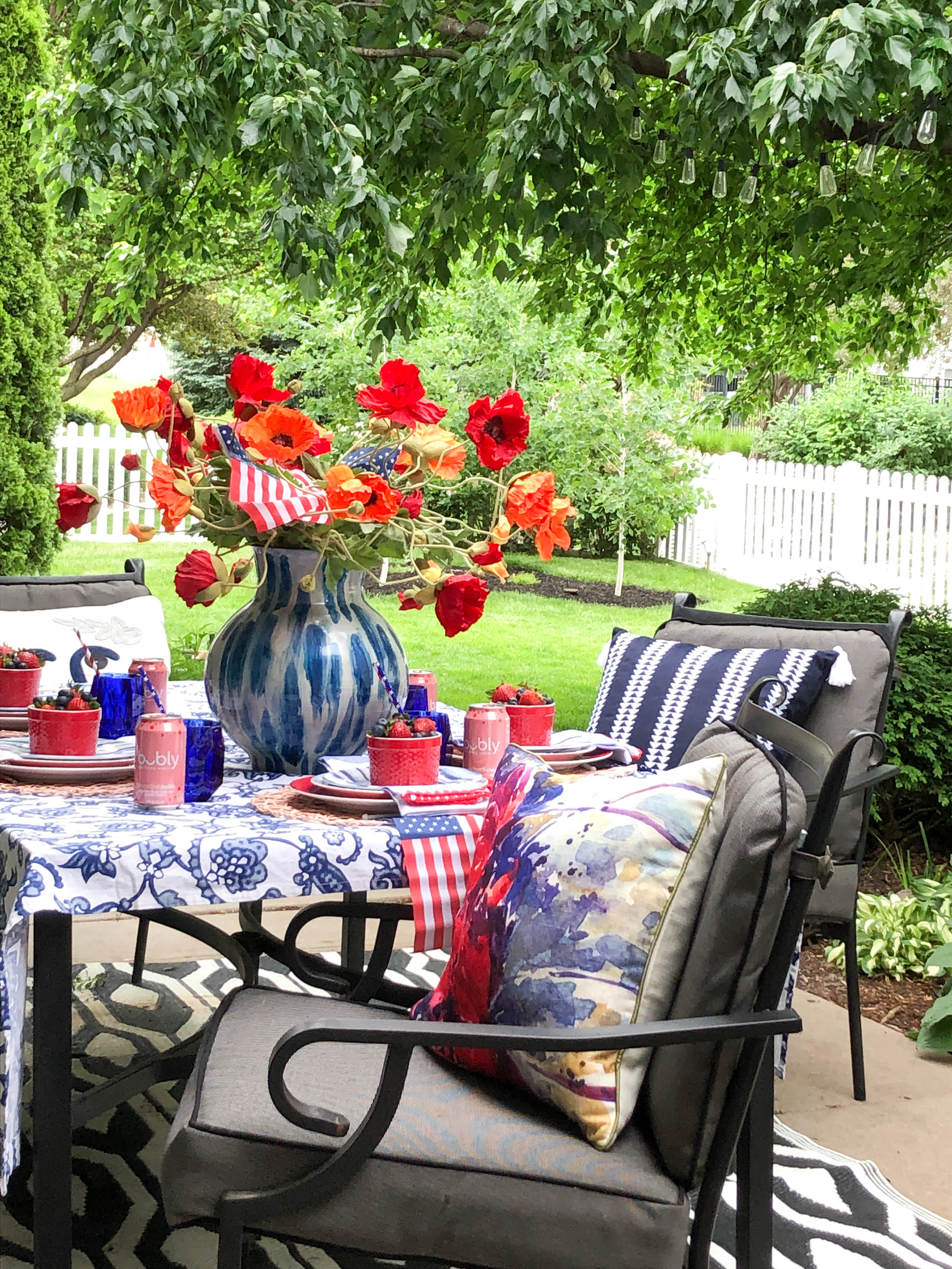 The complete patriotic themed table for Memorial Day or the Fourth of July with table decorations and a grove of aspen trees in the background.