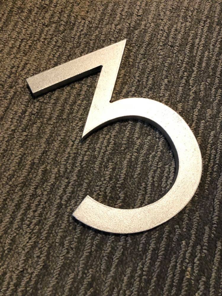 A freshly painted number "3" house number.