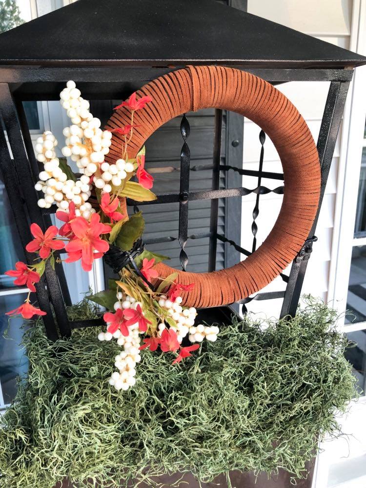 Suede wreath displayed on front porch.