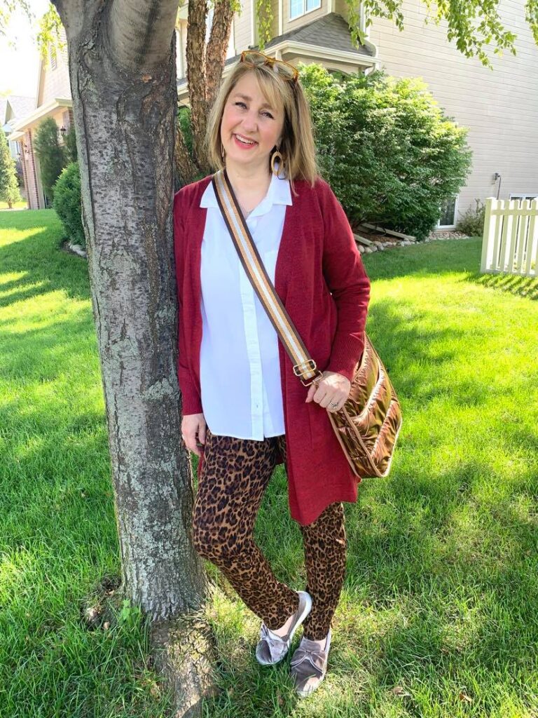 Red cardigan and animal print slim leg pants.