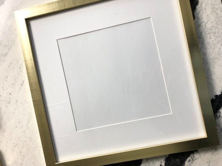 My favorite wall art hack begins with this square, gold frame.