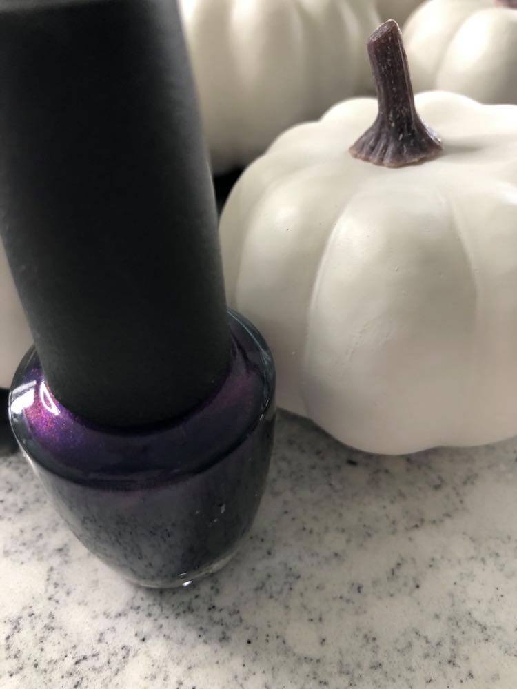 Prepping to paint an abstract pumpkin using white pumpkins with bottle of nail polish in "Russian Navy" color. 