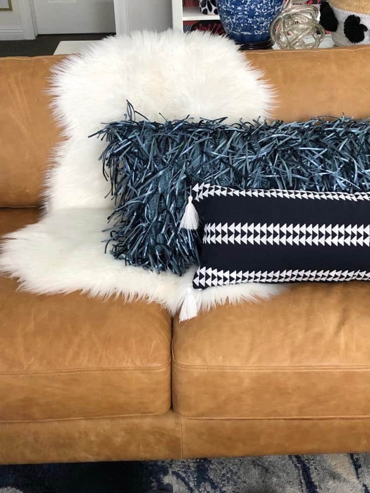 A close up of neutral pillows used to style the sofa.