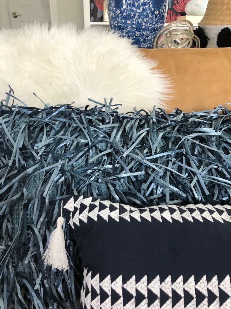 Styling a sofa using navy blue pillows.