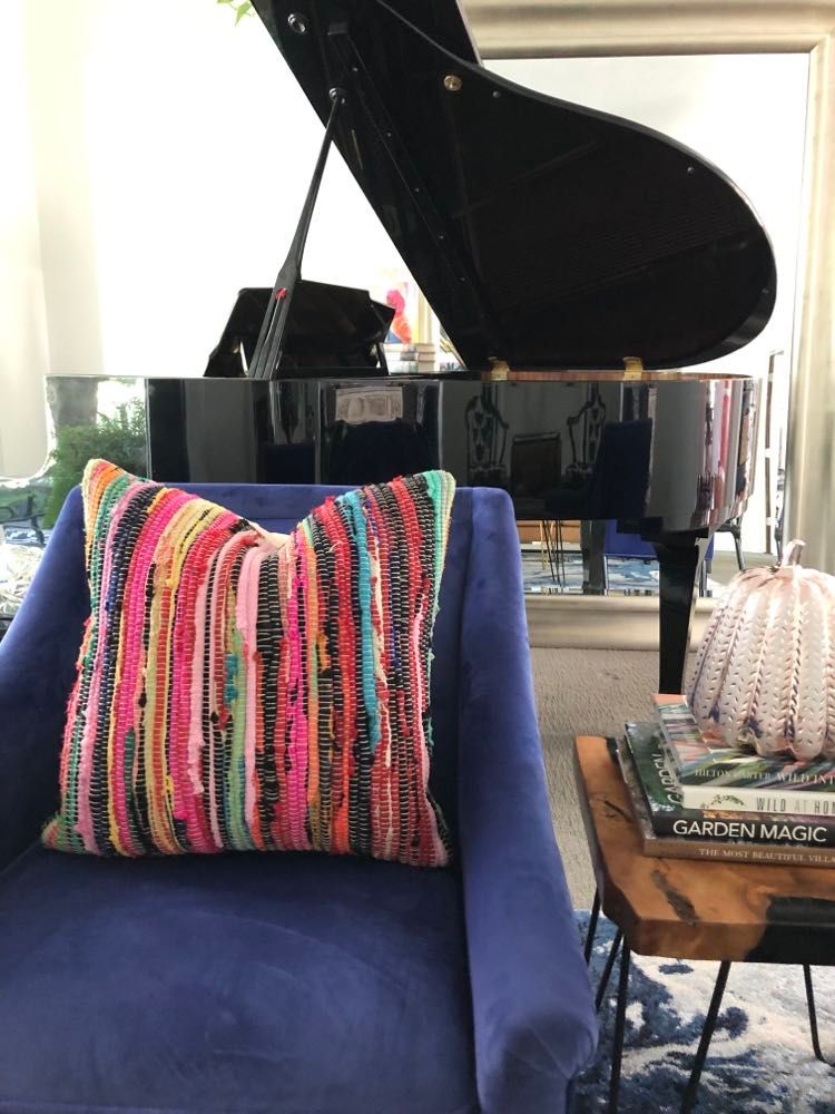 A brightly colored pillow in blues, pinks, and reds.