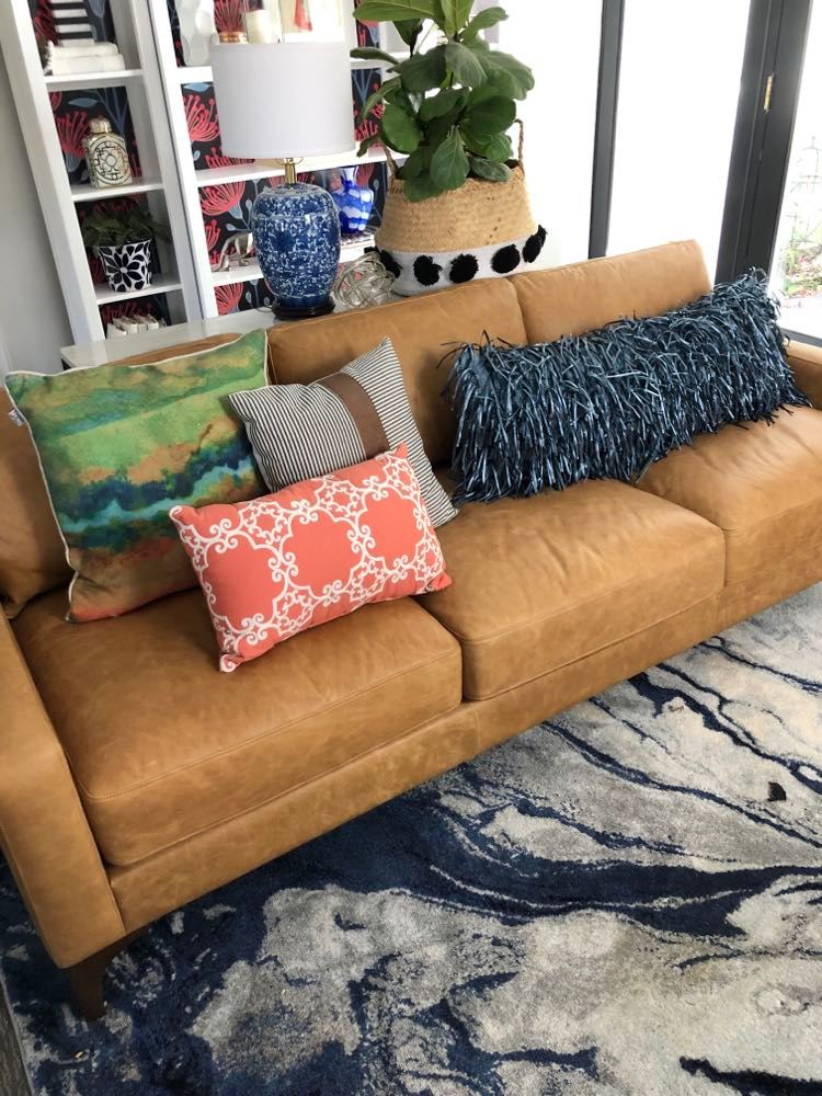 Creatively styling a sofa with colorful pillows.