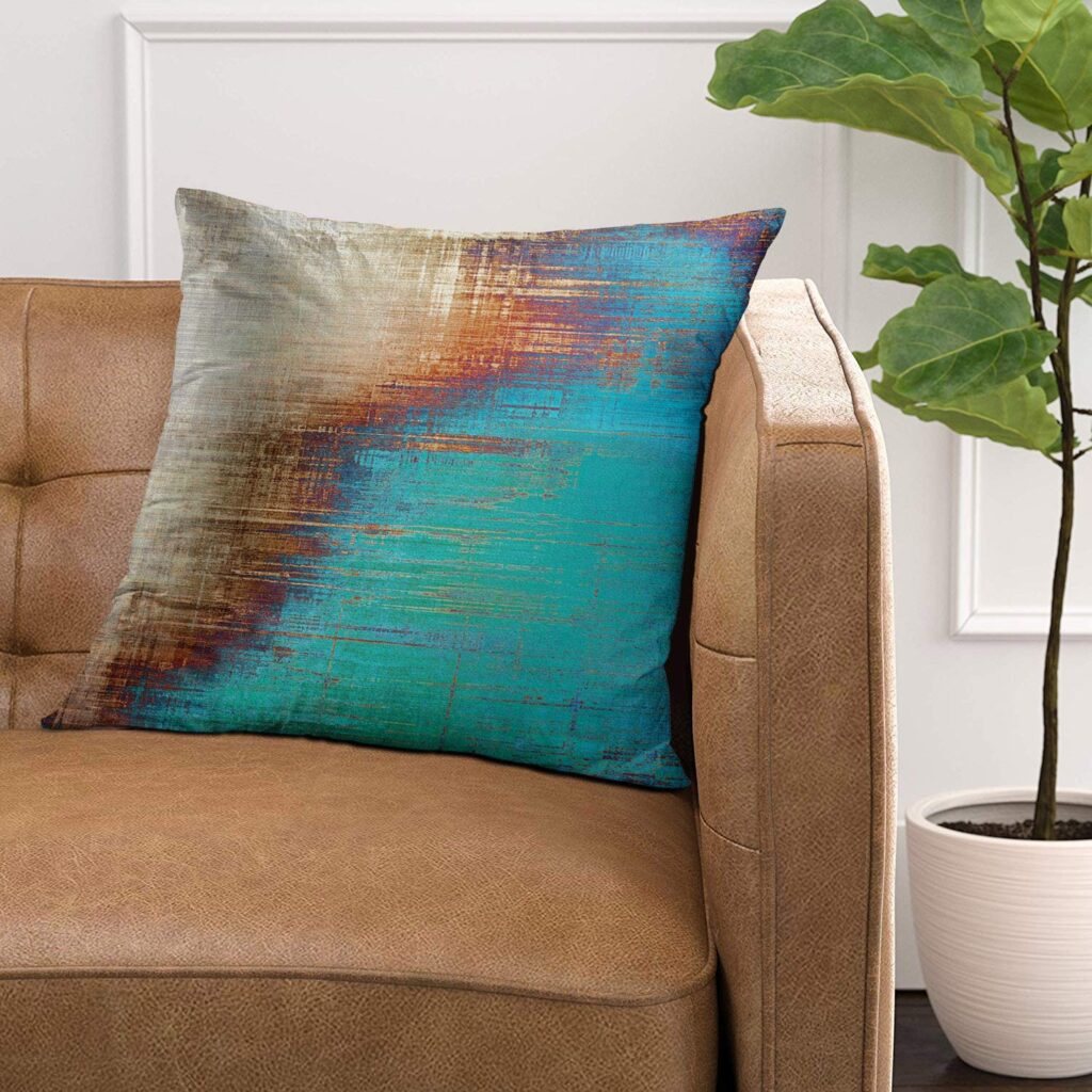 An abstract pillow in blues and oranges.