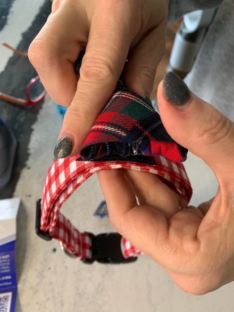 Attaching a plaid tie to a gingham dog collar.