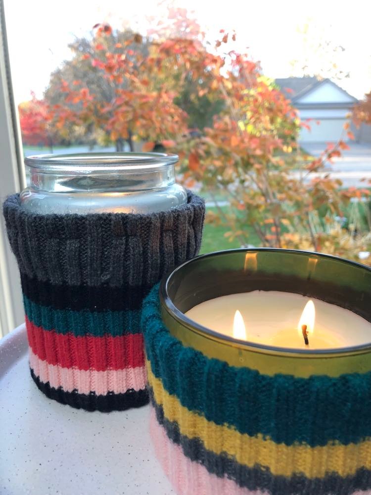 Set of two jar candles with candle wrap made from sweater sleeve.