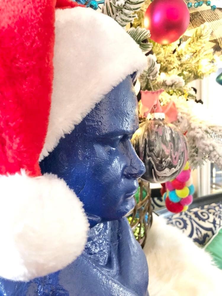 Close up of a bust of Beethoven surrounded by ornaments.