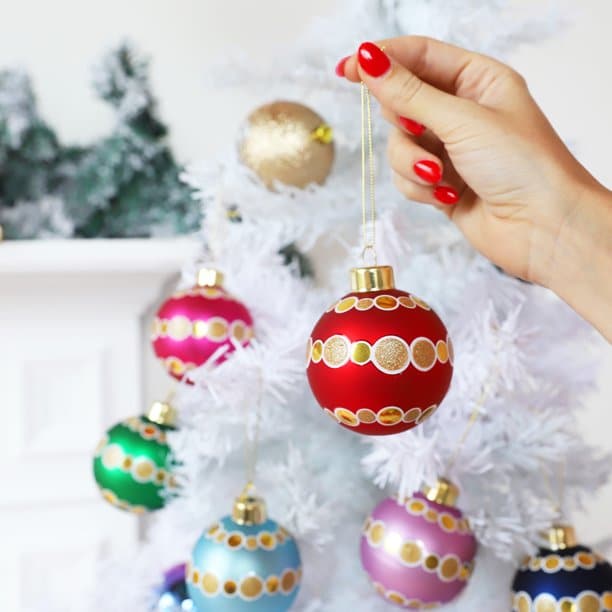 Brightly colored ornaments with gold dots.