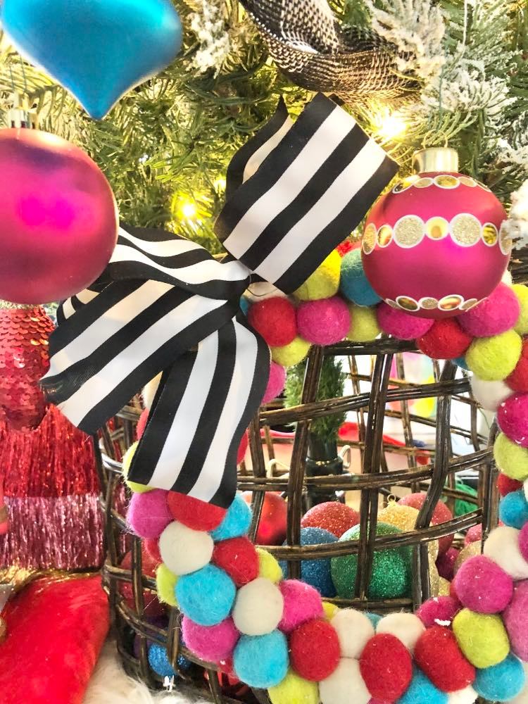 Wool felt ball wreath affixed to tree basket.
