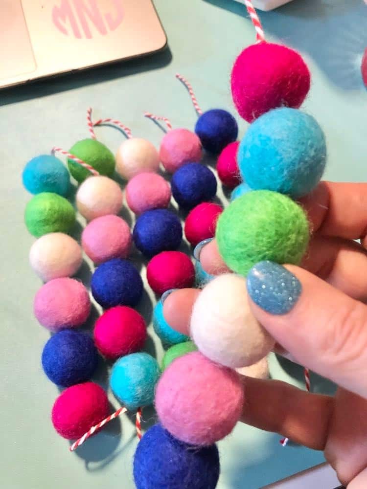 Six Threaded strings of wool balls.