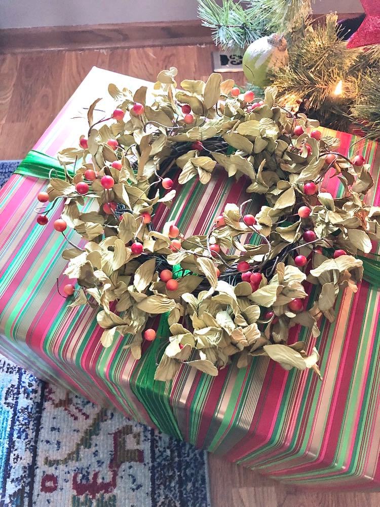 A grapevine wreath used a a bow is a great colorful Christmas gift wrap idea.