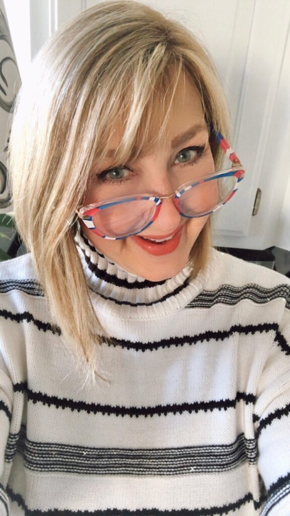 Blue, pink, and white striped reading glasses.