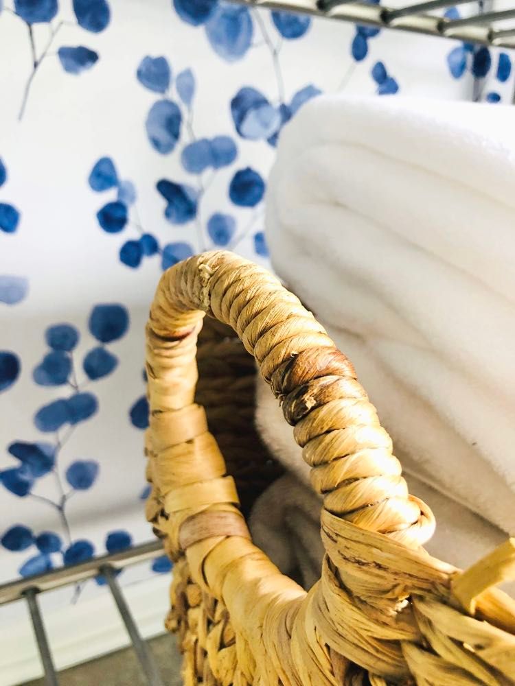 A basket full of white towels.