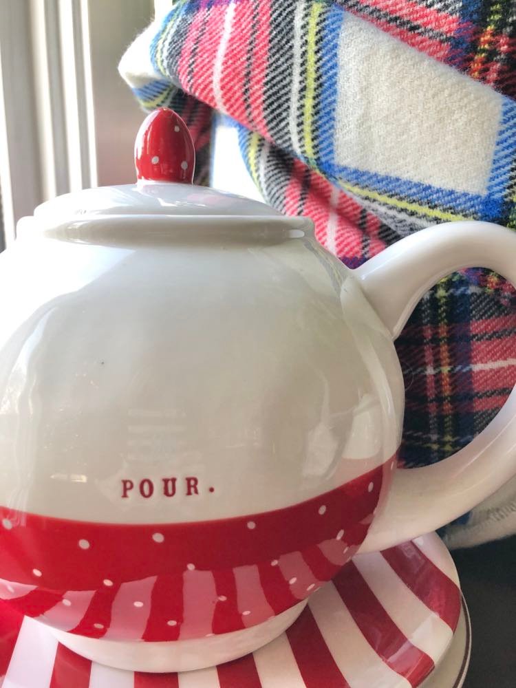 A teapot with the word "pour" written on the side.