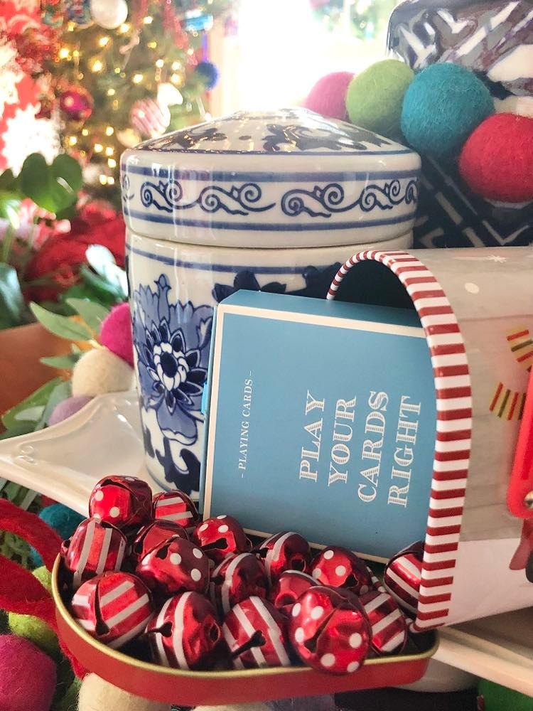 A deck o playing cards peeking out of the Christmas mailbox.