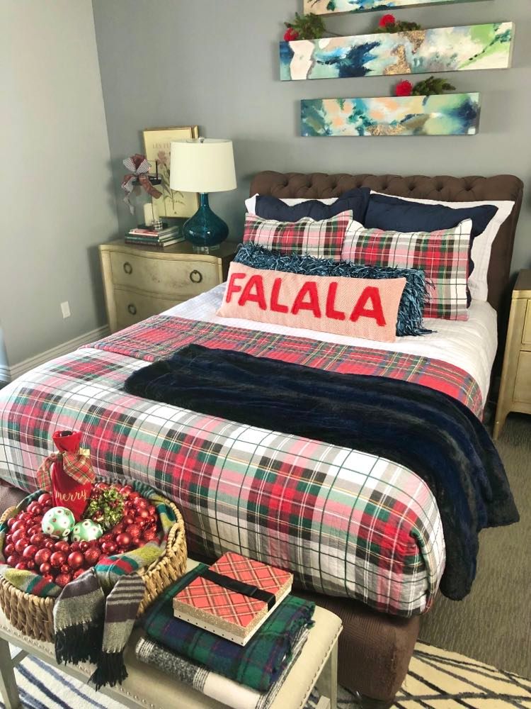 A bed with various plaid patterns and pillows to welcome guests.