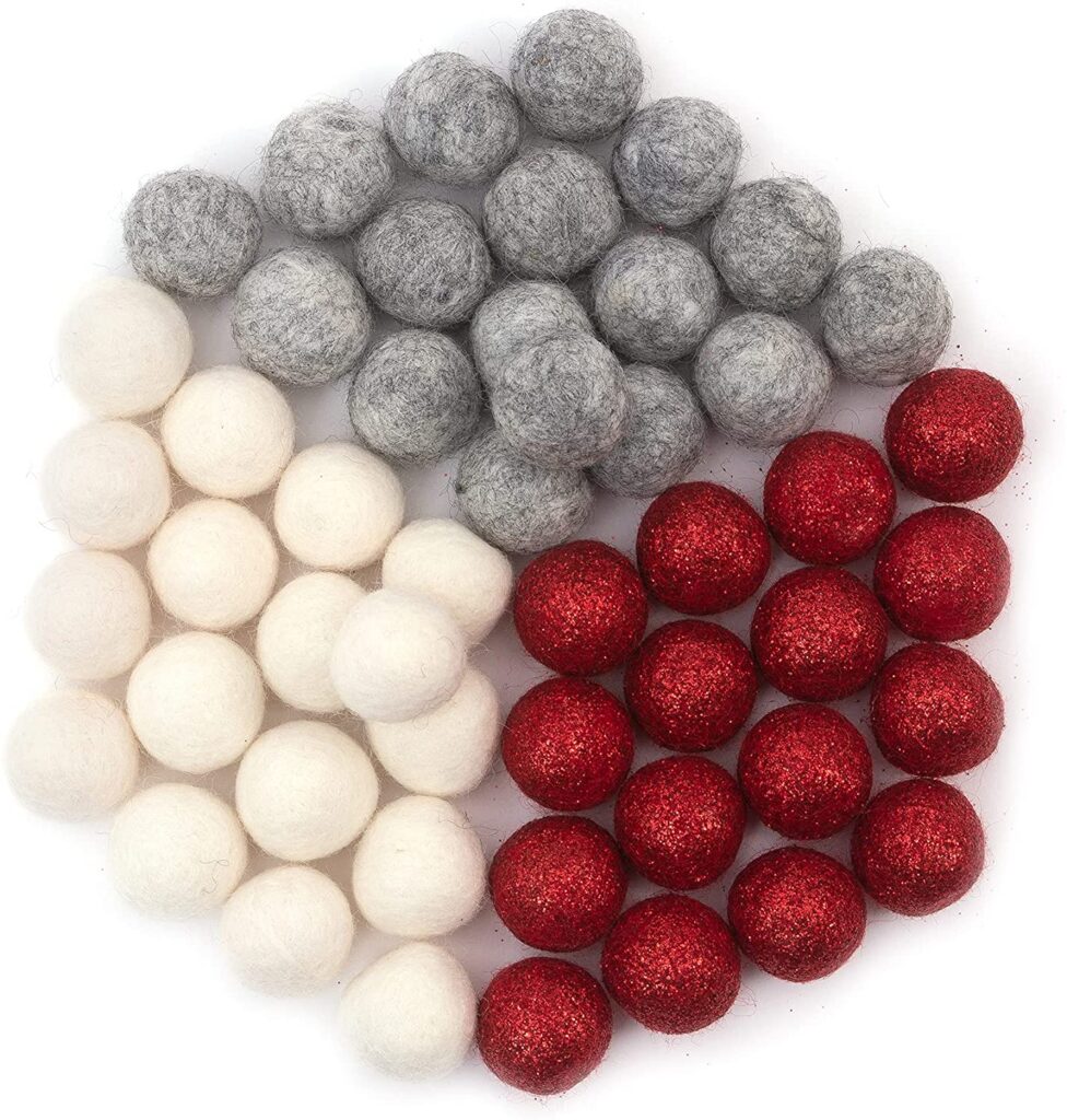 Felted wool balls in white, grey, and red.