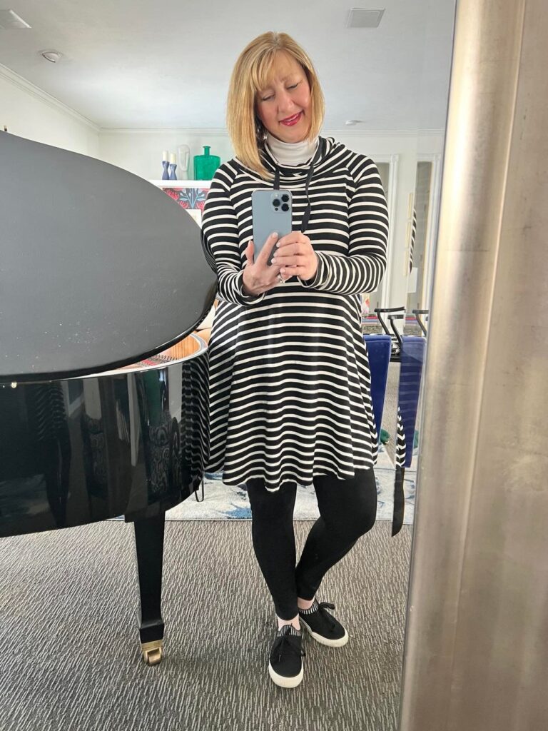 White turtleneck layered under a black and white stripe dress.