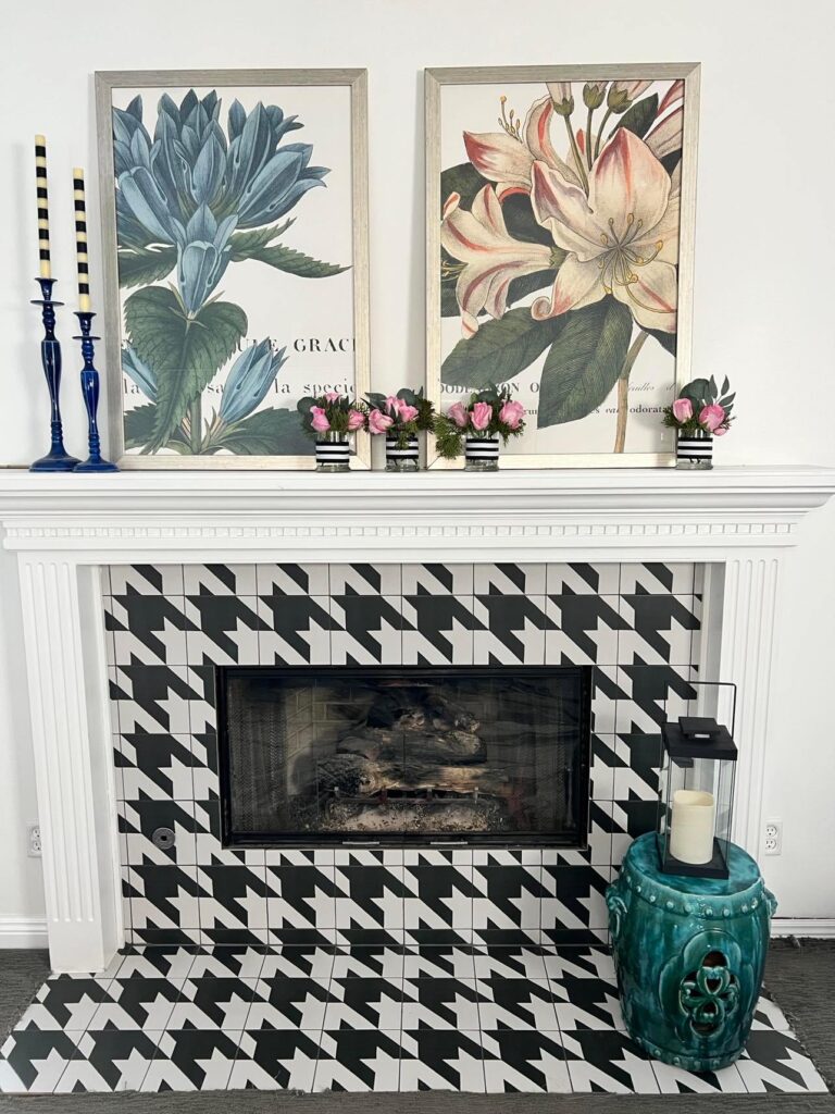 A fireplace decorated with pink roses in glass vases. a great way to transition from Christmas to winter decor.