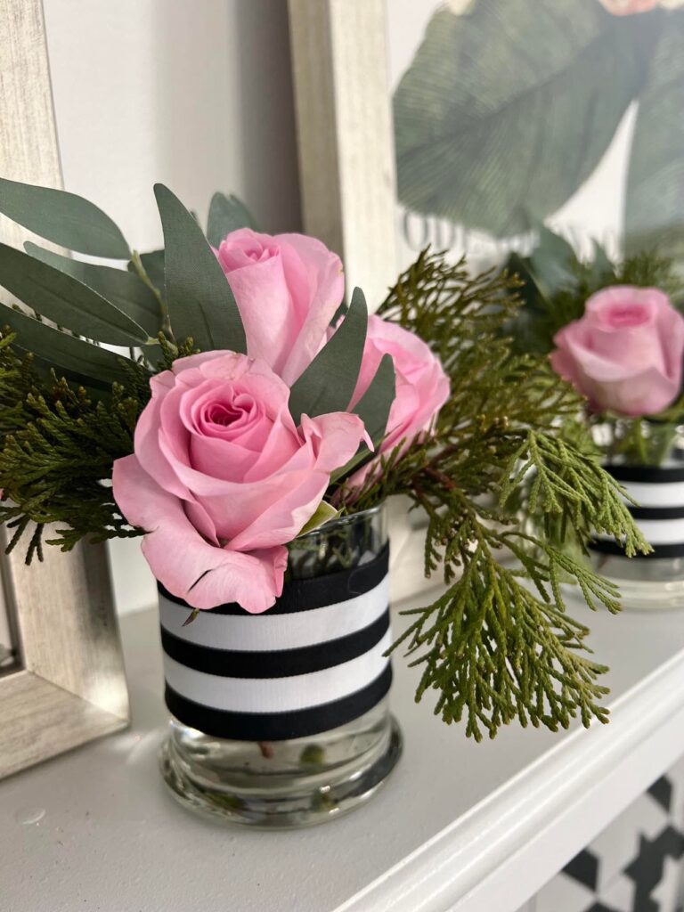 A small flower arrangement featuring pink roses.