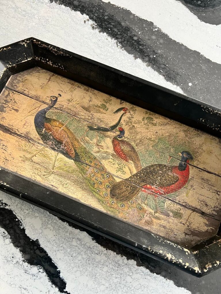 A wooden tray with pheasants painted on the body.