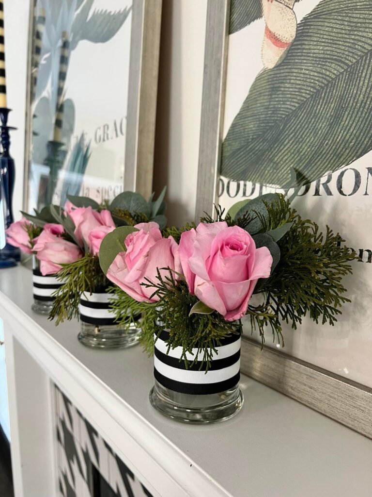 Small flower arrangement displayed on a fireplace mantel.