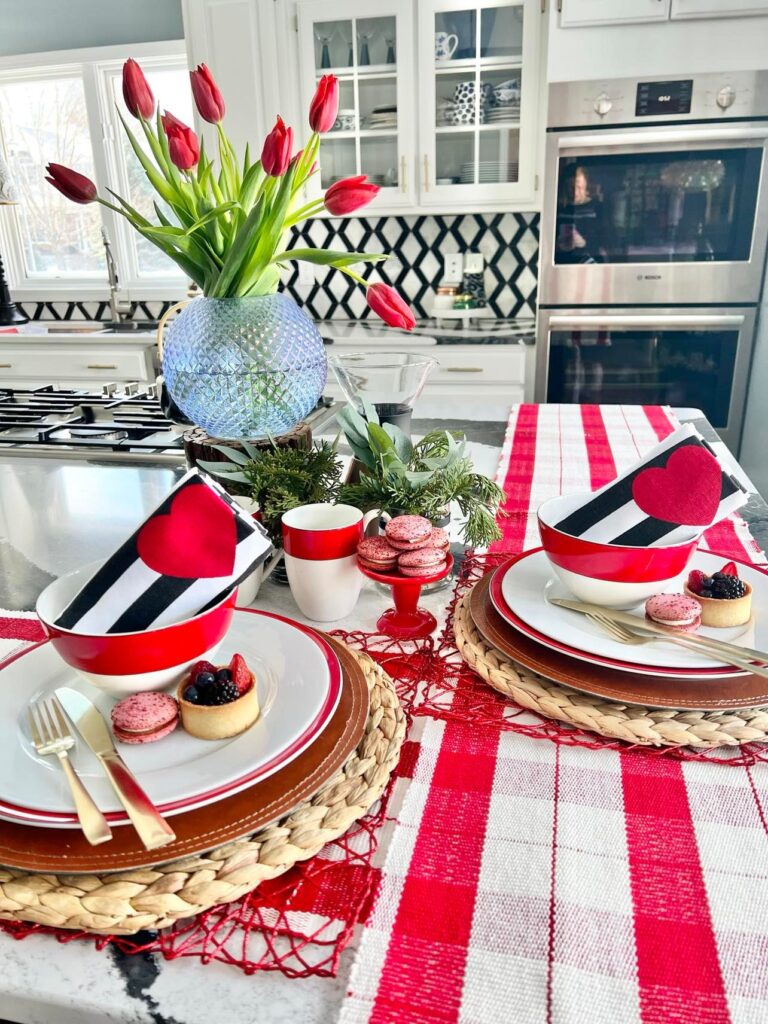 Red and white dinnerware and table runner are Valentine's Day home decor for the kitchen.