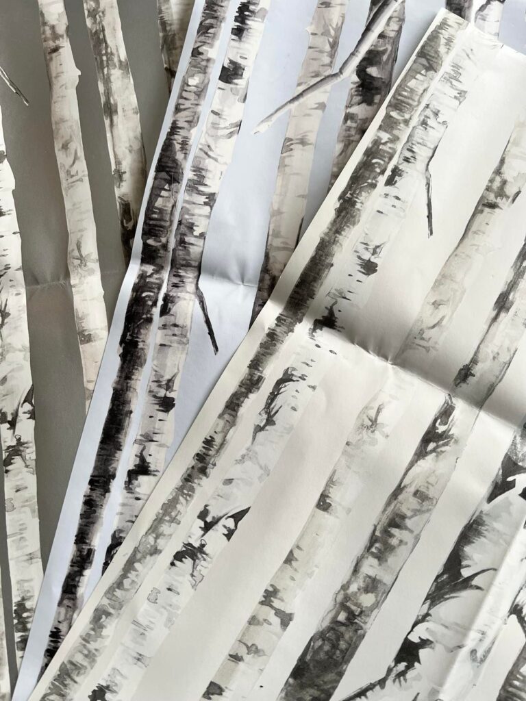Wallpaper samples with birch tree patterns.