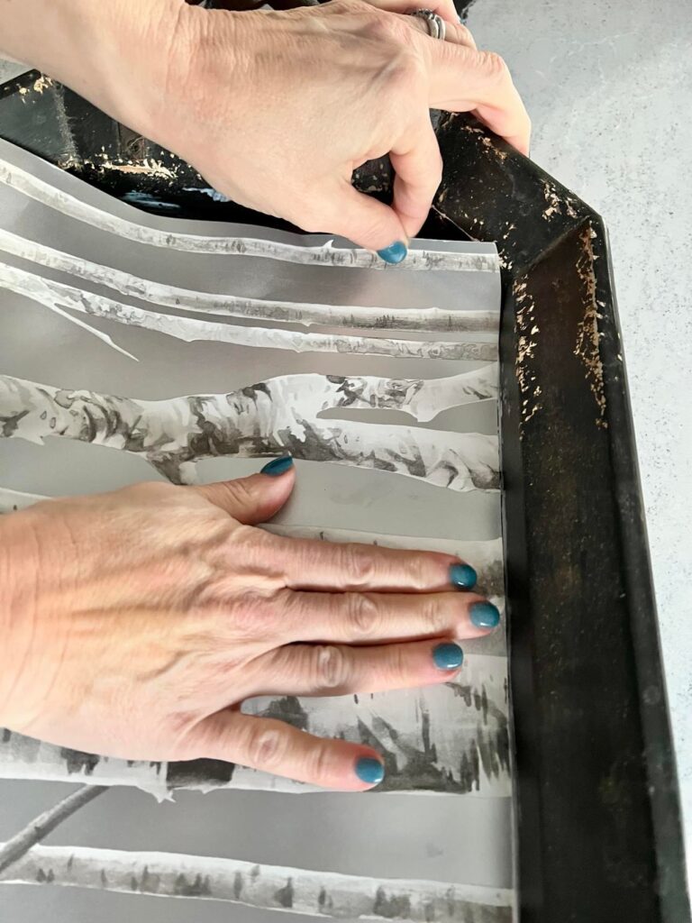 Aligning wallpaper on to a tray.