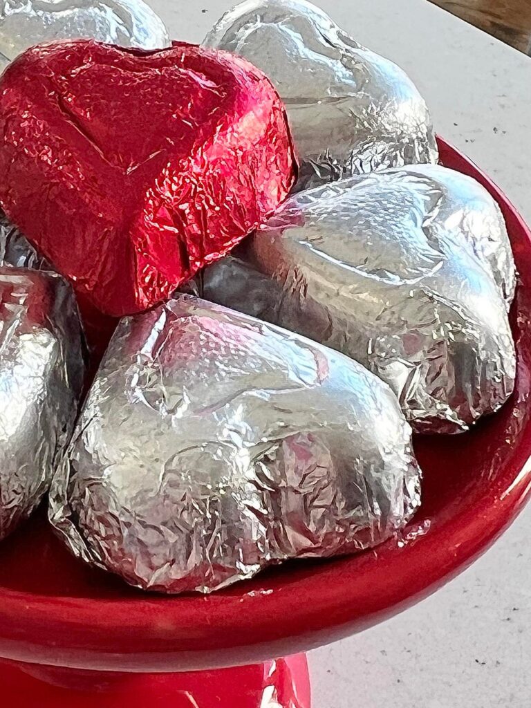 Decorate for Valentine's Day with a plate of foil wrapped chocolate hearts.