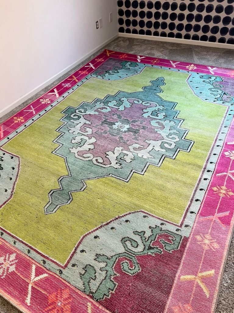 Creating a craft room with a bold and colorful rug in colors of green, pink, light blue, and lavendar.
