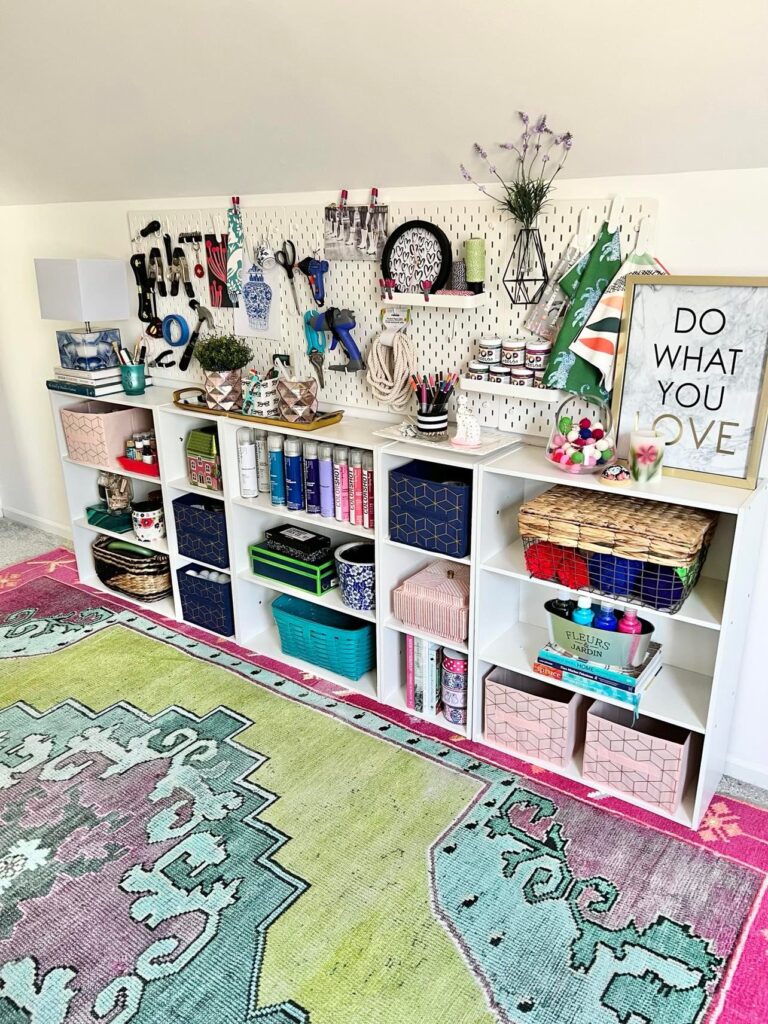A craft room storage wall that is fully loaded with needed craft supplies.