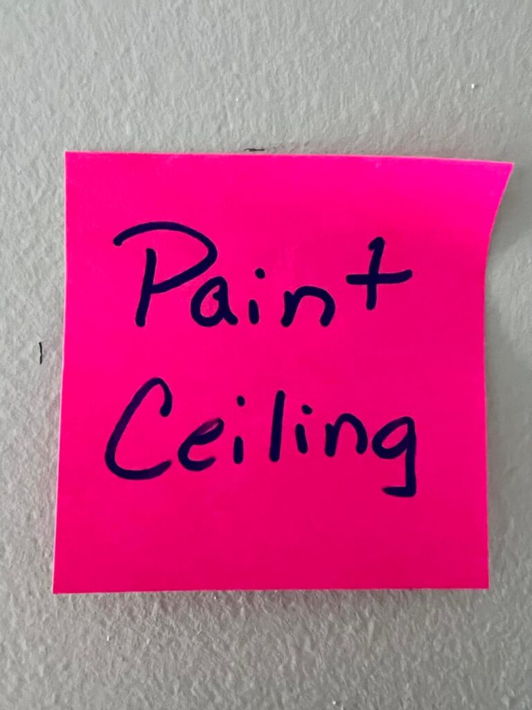 A pink sticky note that say's "Paint Ceiling."