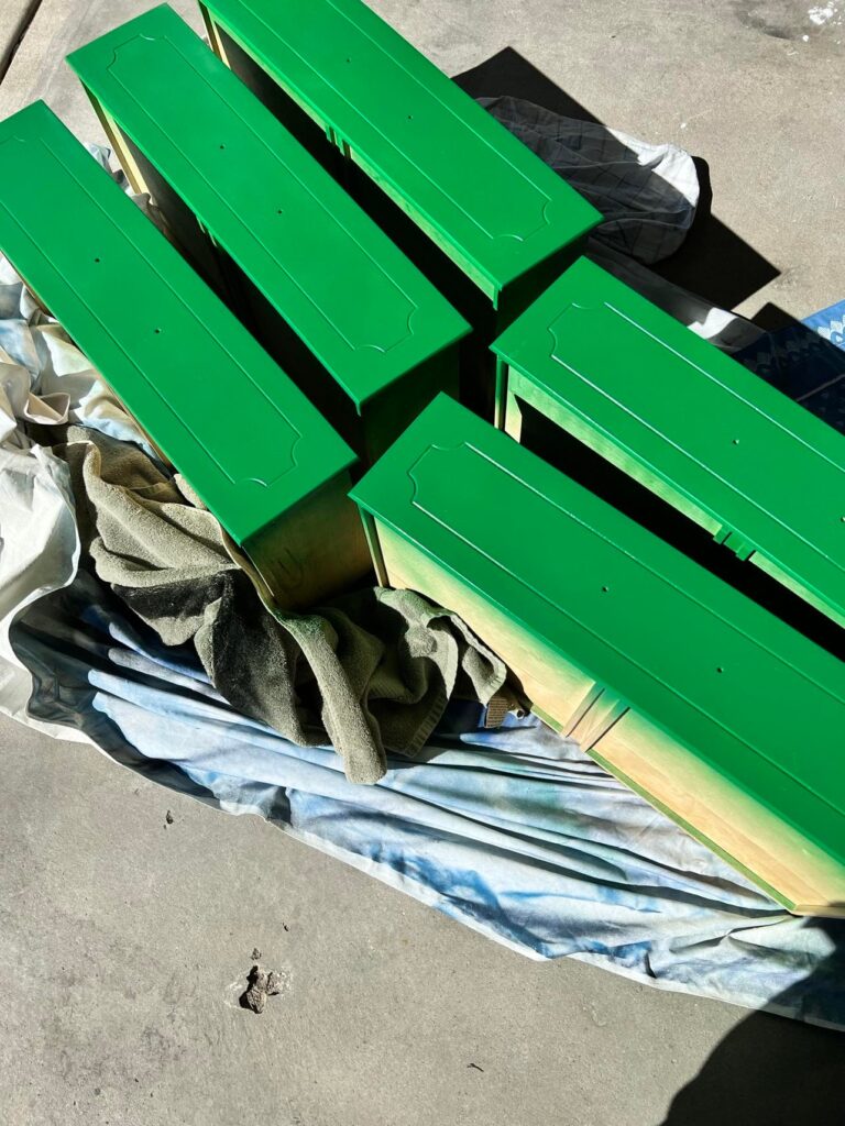Dresser drawers that have been painted a bright green.