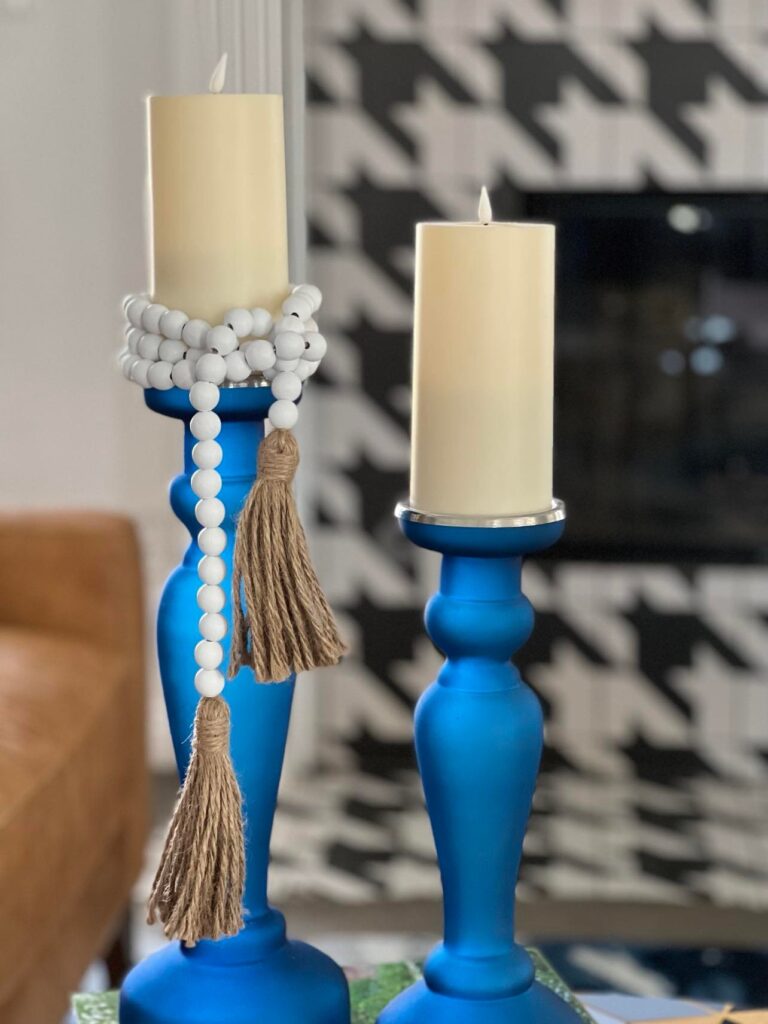 Blue candlesticks wrapped in white bead garland. How to decorate with bead garland.