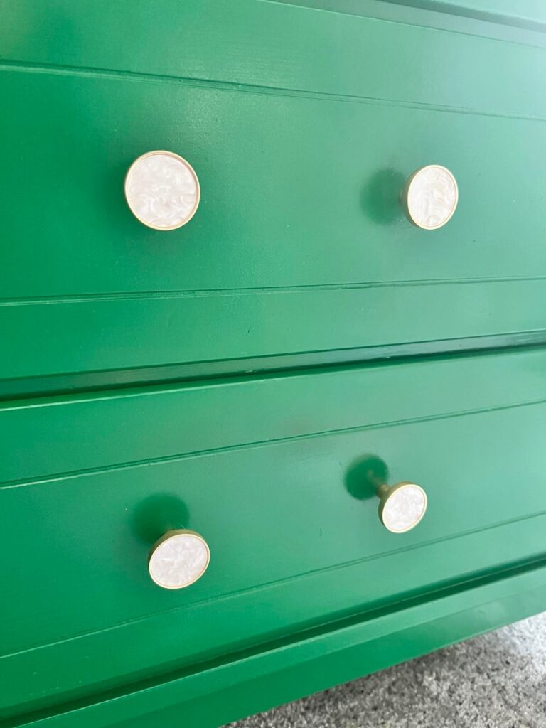 Green drawers with new white and brushed brass knobs.