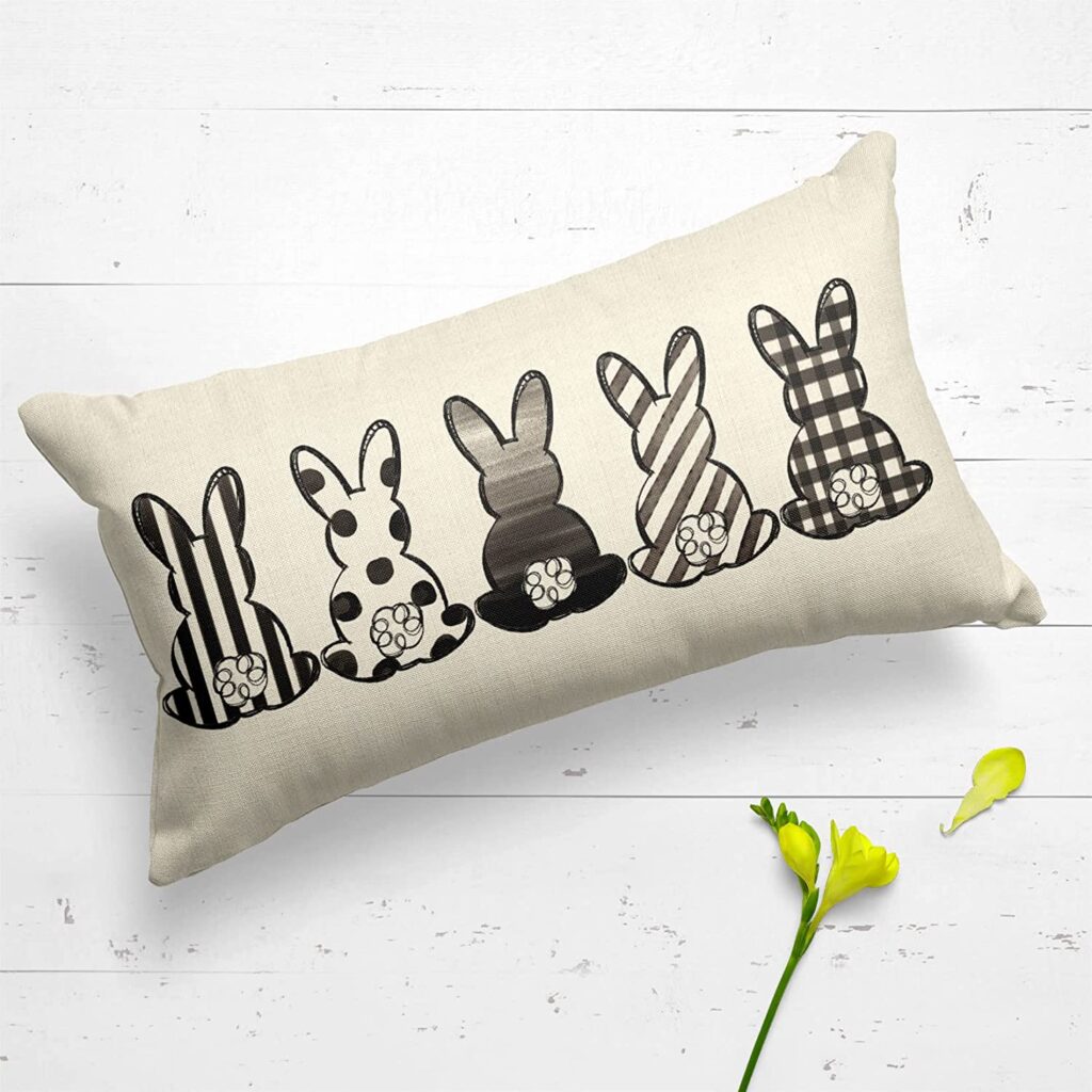 A bunny pillow for purchase with black and white patterned bunnies.