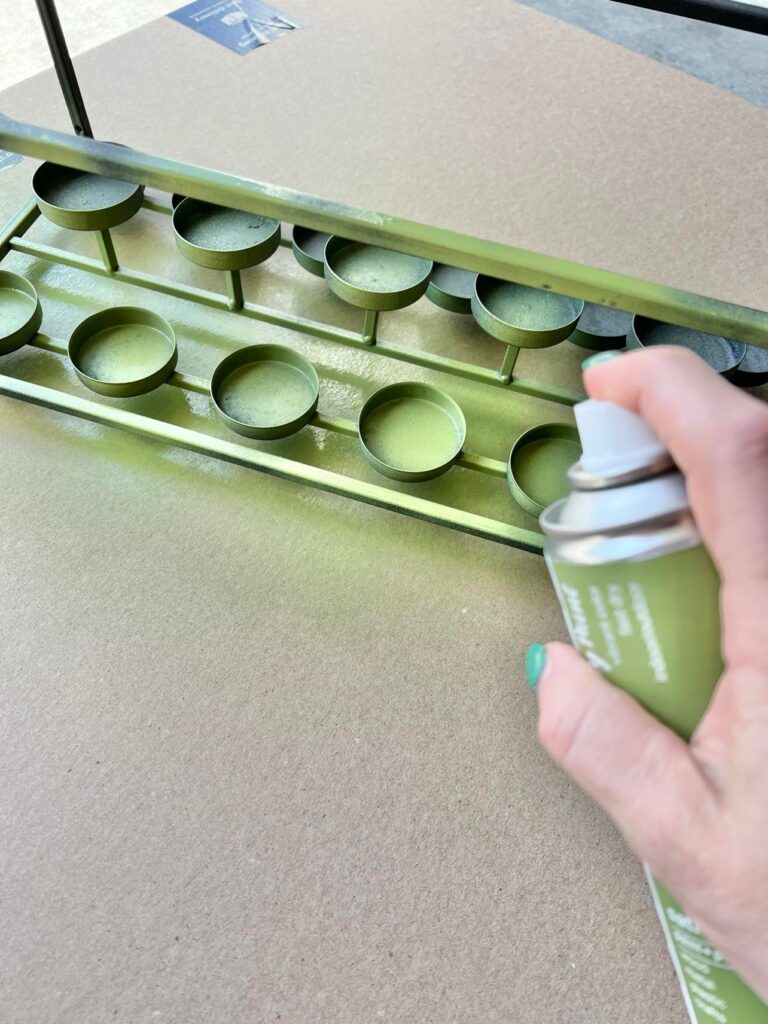 The Easter Table Centerpiece consists of the metal votive holder being spray painted in the green color.