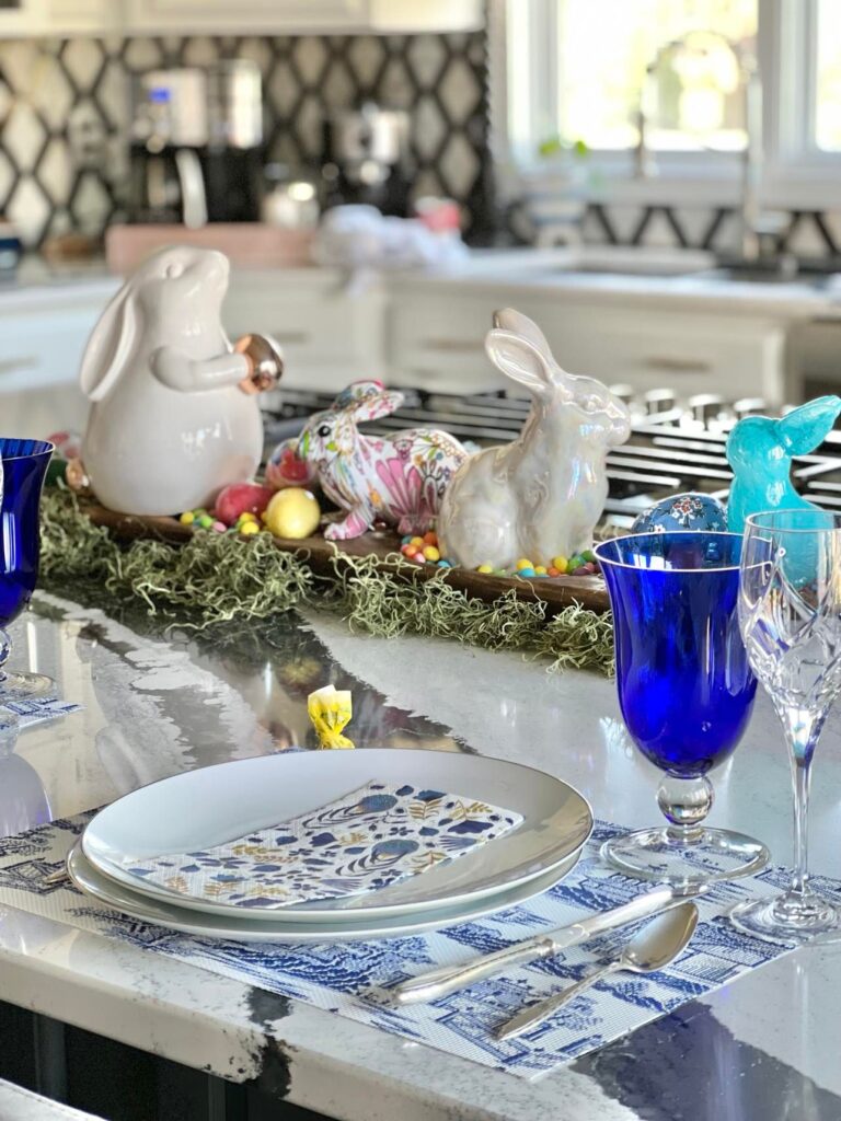 An Easter tablescape on a kitchen island with a dough bowl centerpiece.