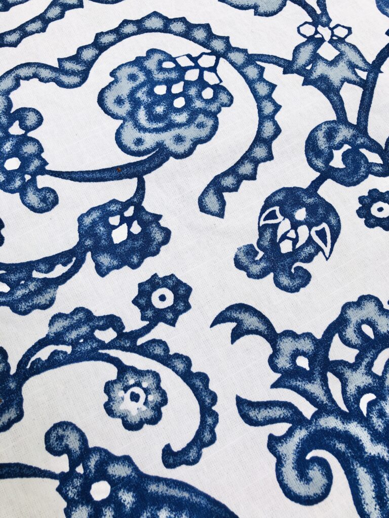 A blue and white patterned shower curtain will make the perfect tablecloth.