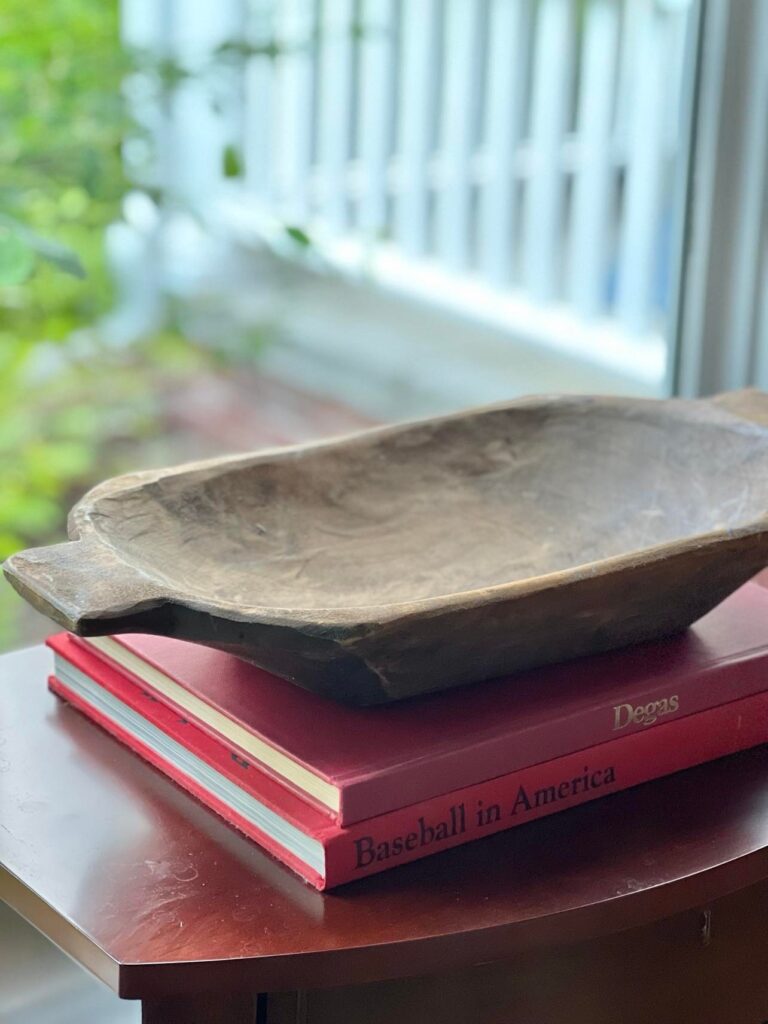 An empty dough bowl sitting on a stack of red books.