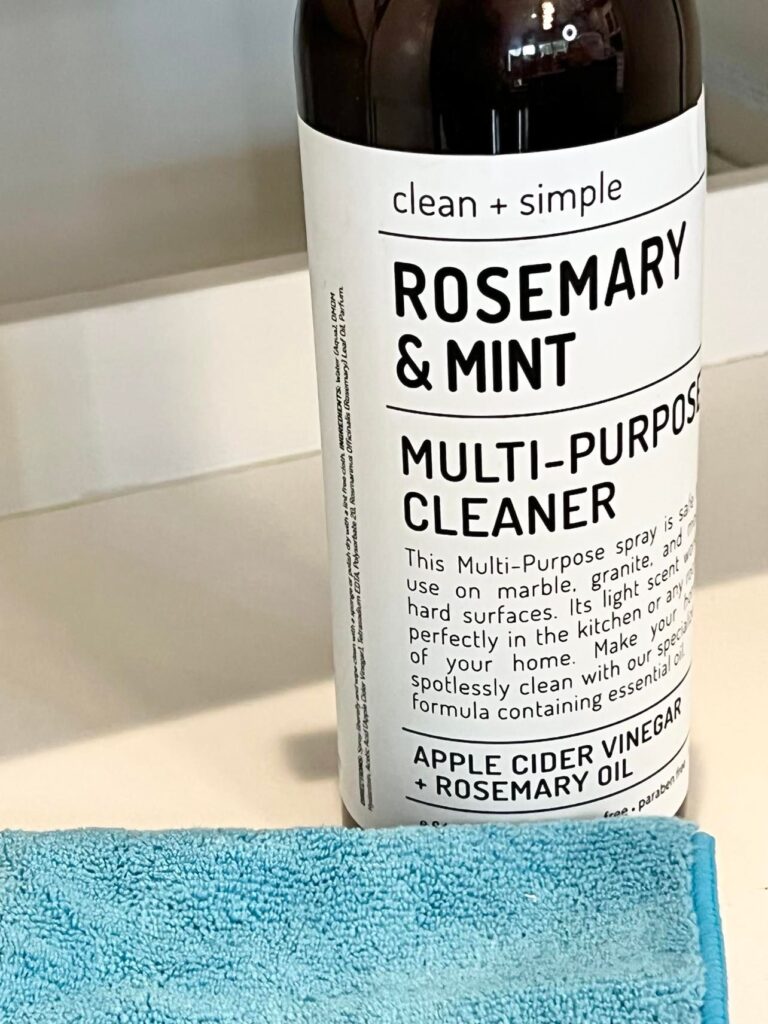 A bottle of all-purpose cleaner and a microfiber cloth.