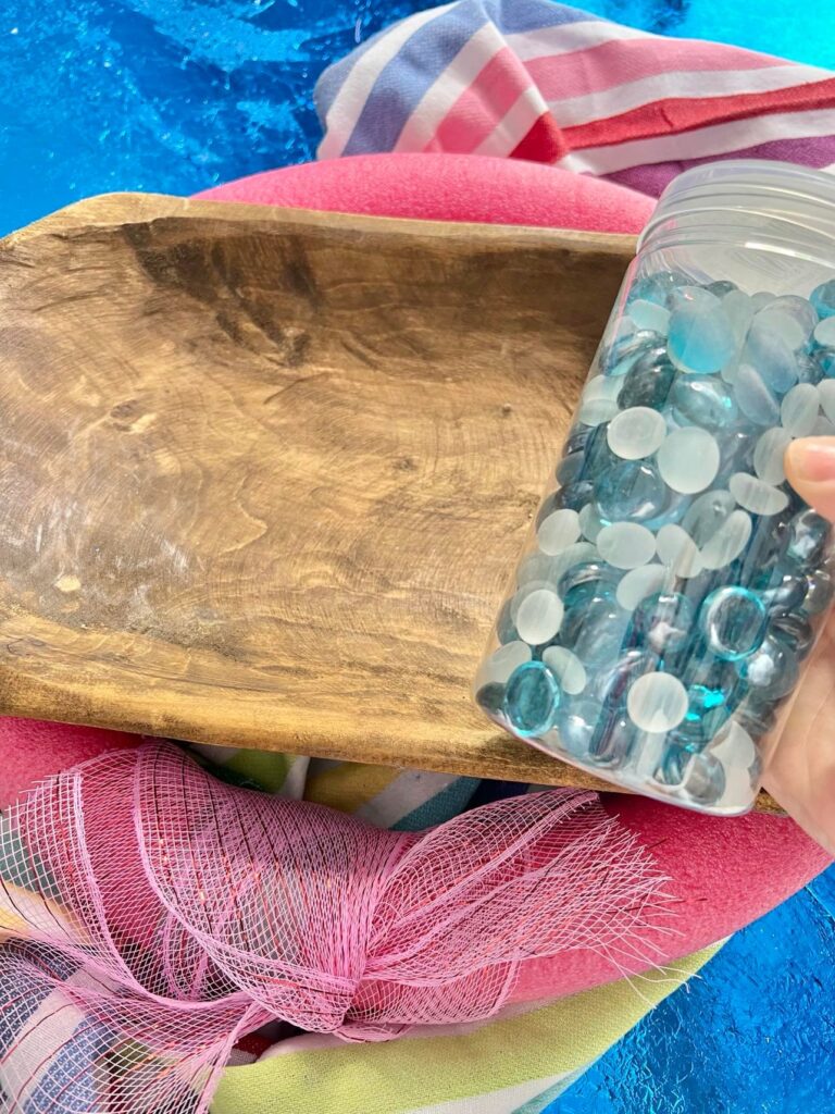 Shades of blue pebbles and the dough bowl are the key pieces in this summertime dough bowl idea.