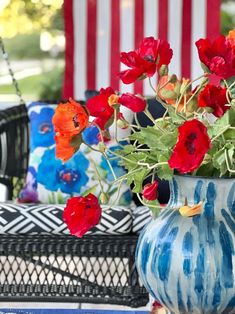 A close up shot of the orange and red poppies used to decorate the front porch for July 4th.