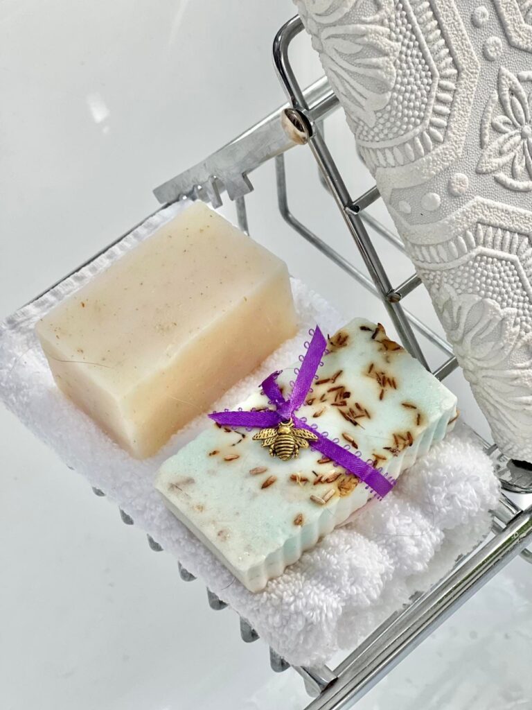 Natural soaps sitting in a bathtub tray are perfect for a budget-friendly bathroom spa experience.