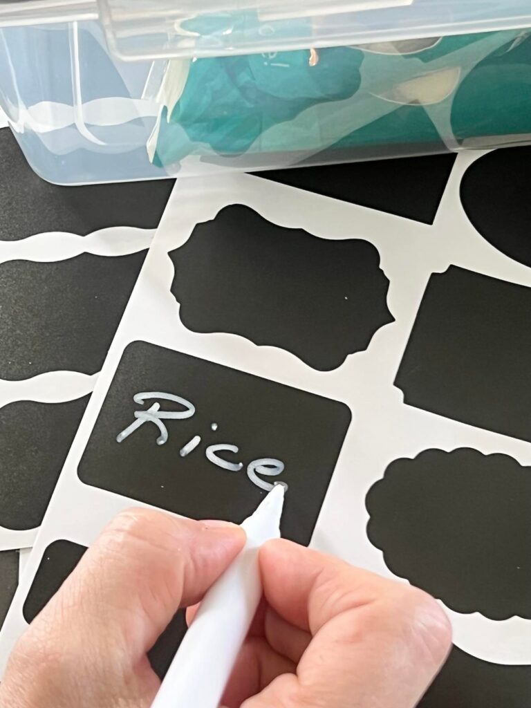 Black labels with a white marker pen. Perfect way to organize a pantry with roll-out drawers.
